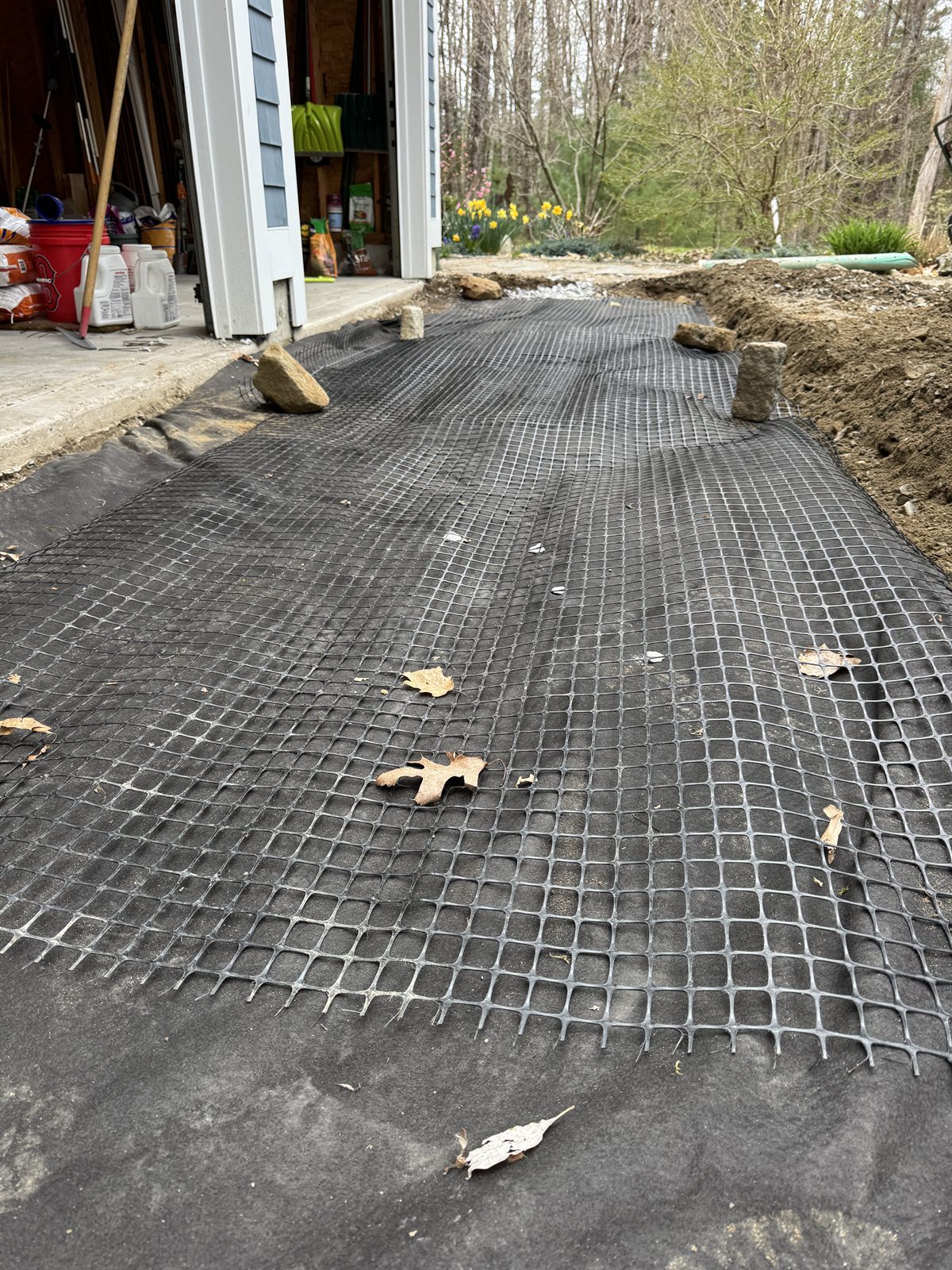 Geogrid over clean stone in a GSS drainage build, Seacoast NH