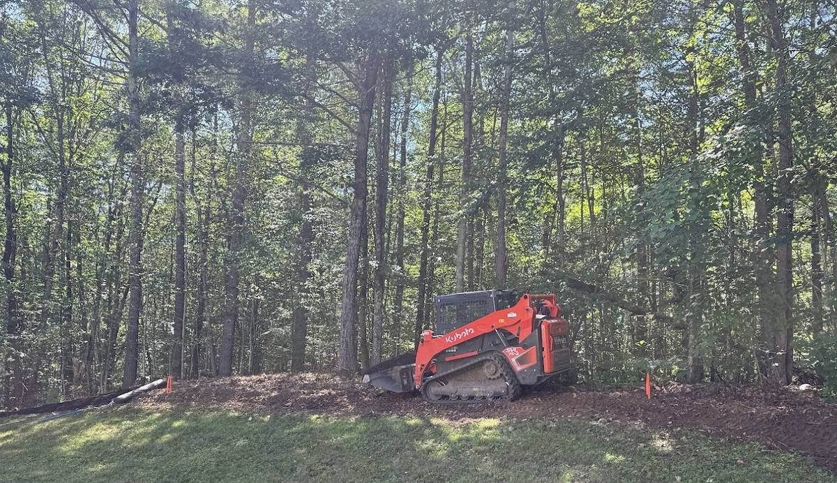 Kubota building a forest access trail with drainage and water control, GSS New Hampshire