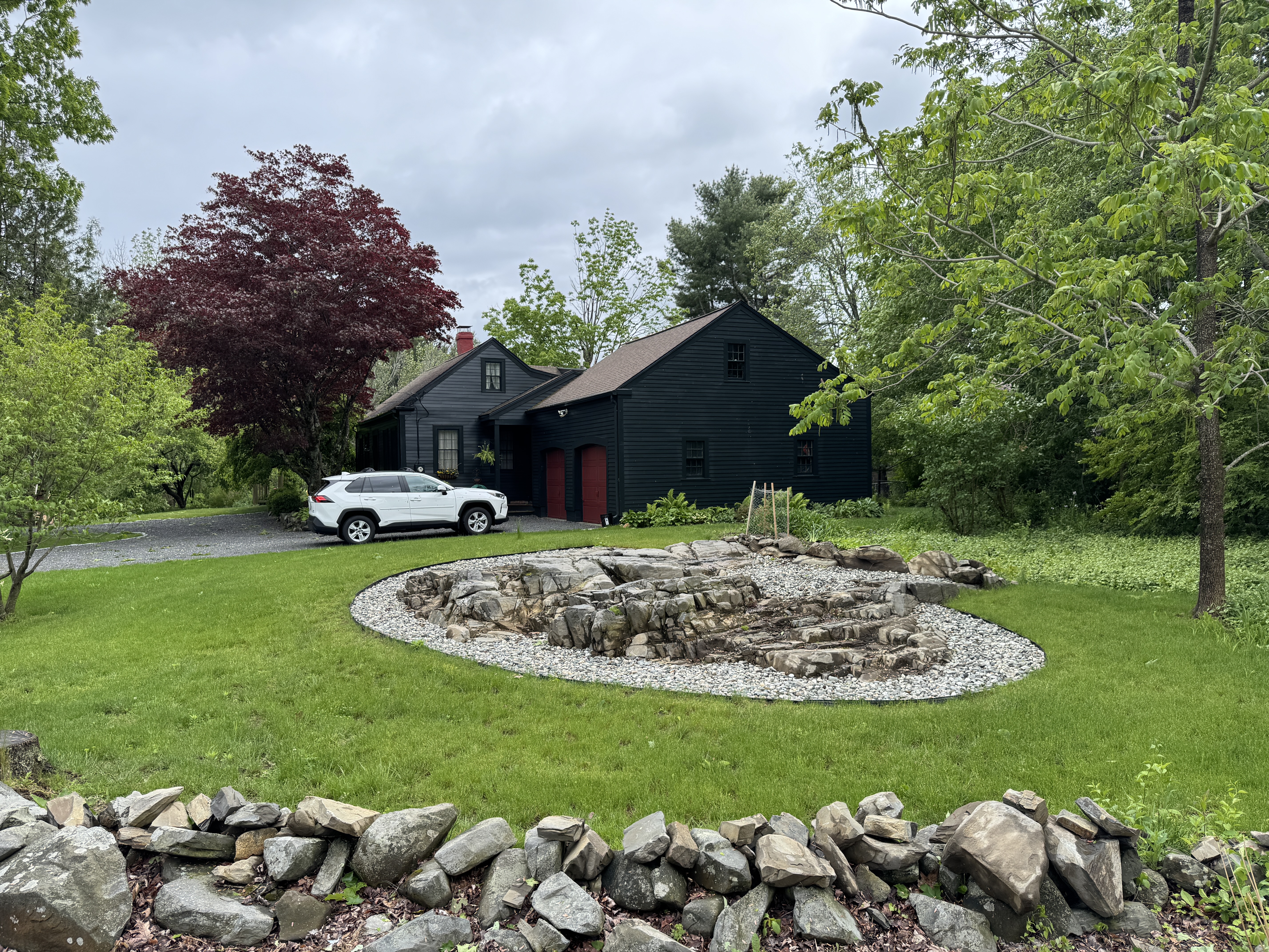 Established front-yard turf around stone garden feature — GSS lawn renovation