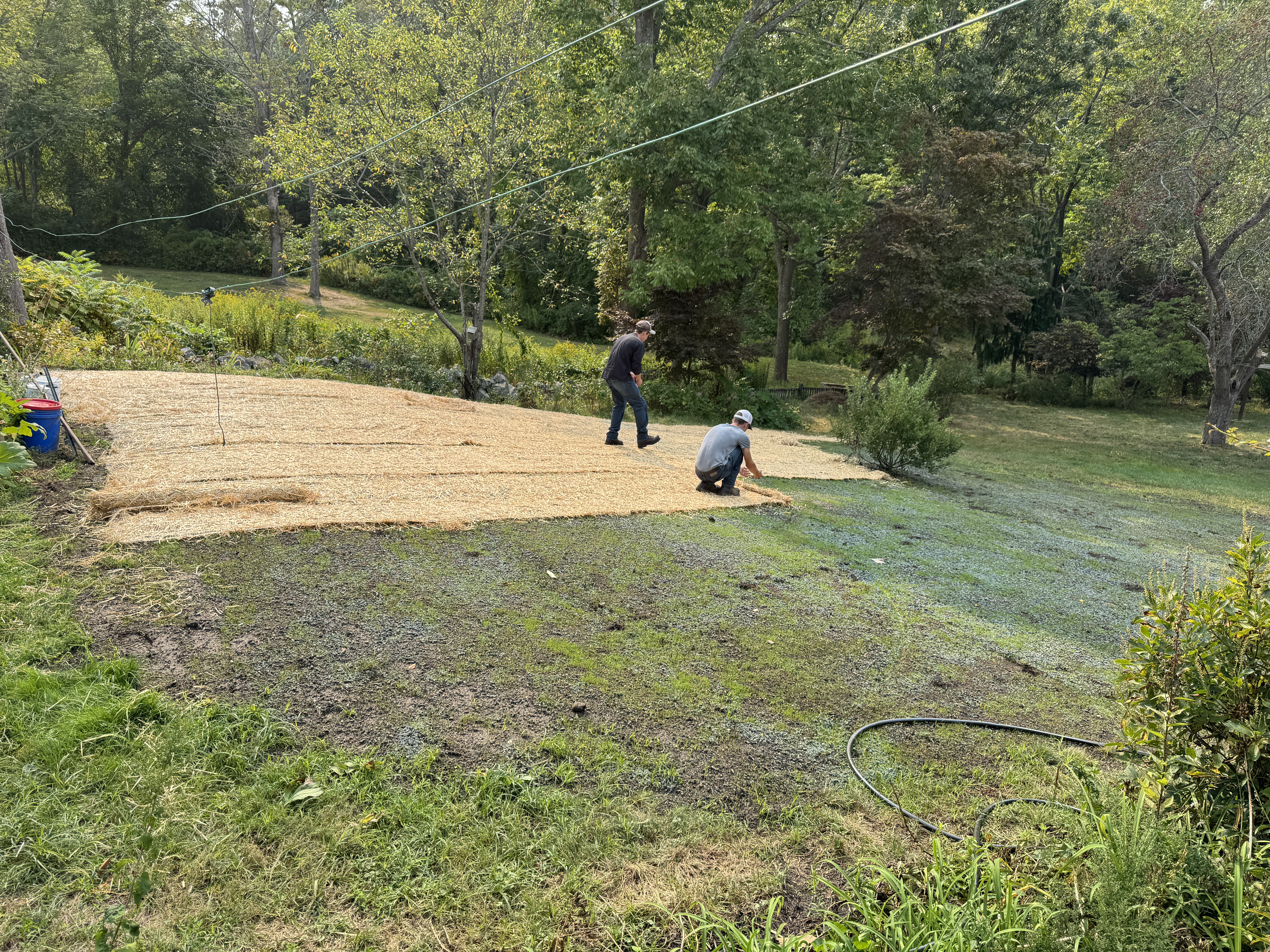 GSS crew applying hydroseed and straw mulch on a Seacoast NH lawn renovation