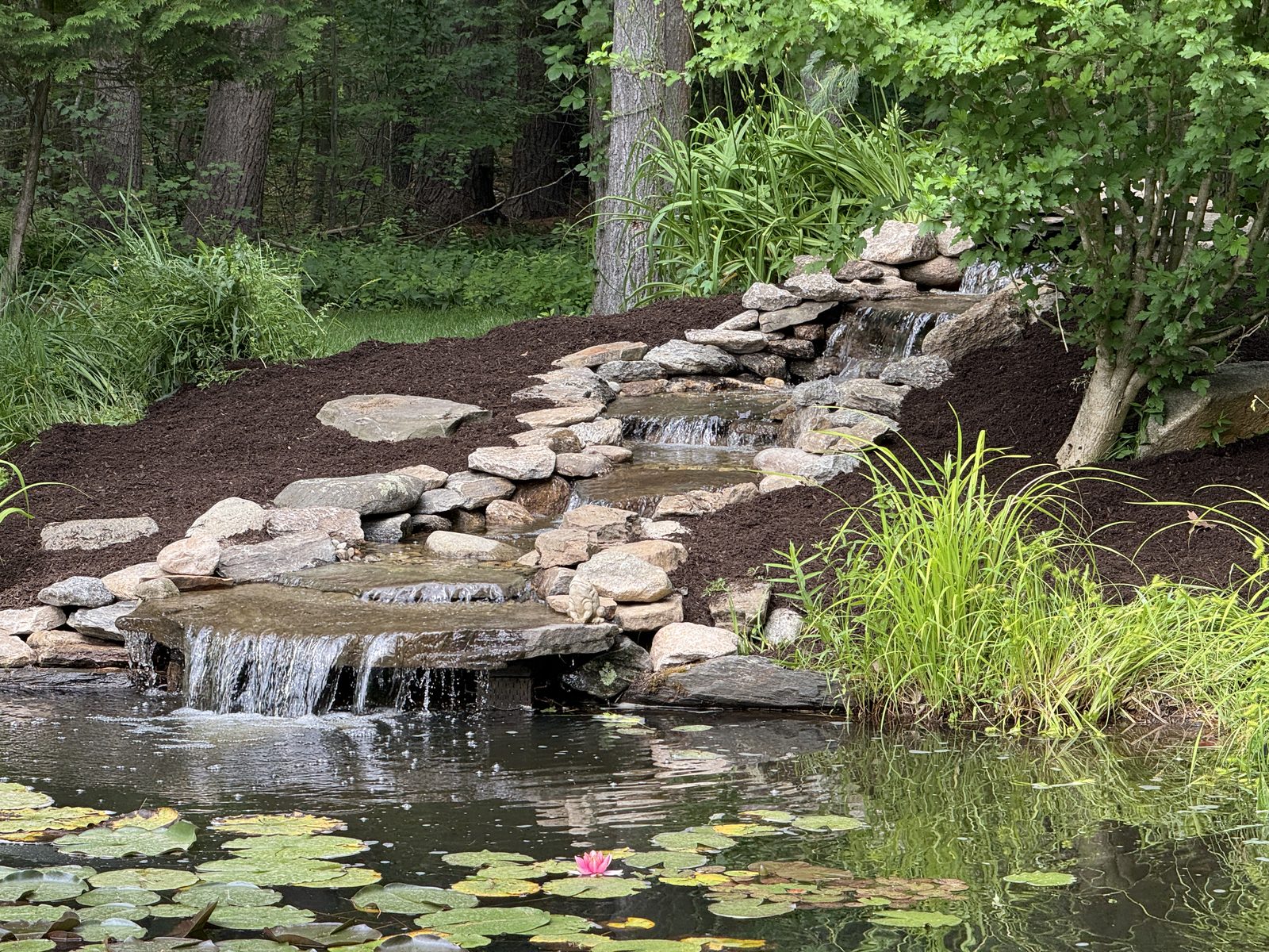 Pools-and-drops stone stream feeding a renovated pond, GSS water feature NH